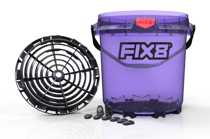 Detailer working around vehicle with bucket system